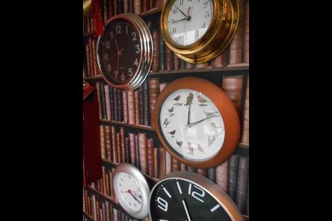The British part of the equation is realised through the use of a small wall with leatherbound volumes and wall clocks and a shelf with a decanter of whisky.